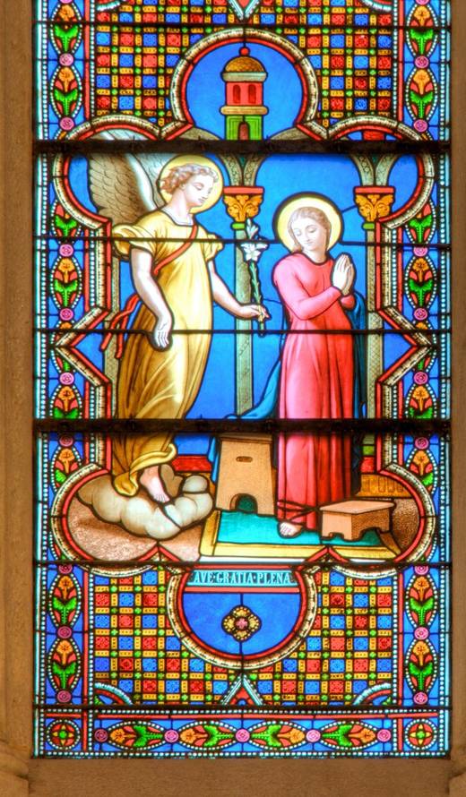 The Annunciation: Gabriel offers a lily to Mary at her prie-dieu.