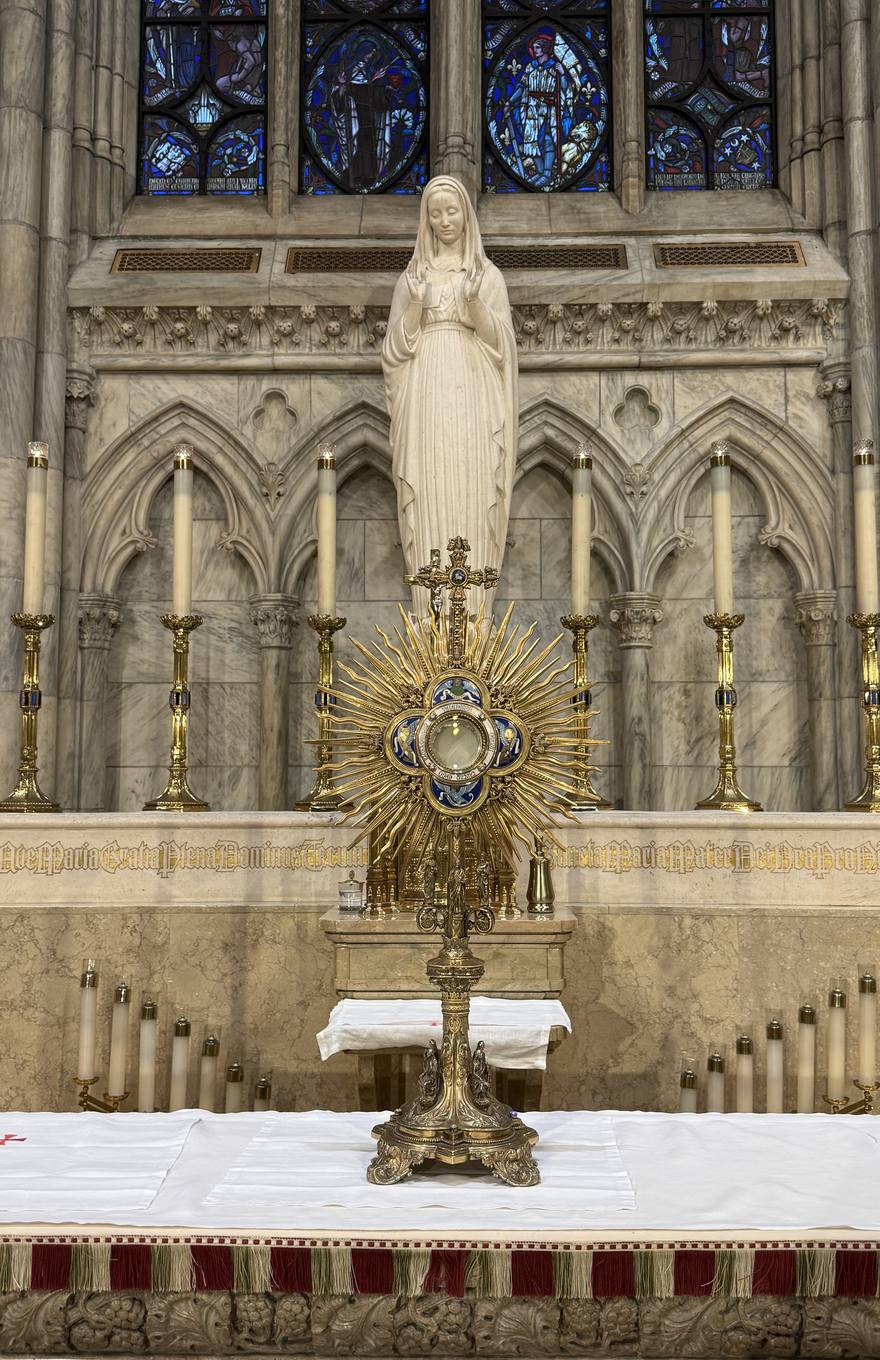 The Lady Chapel altar beneath the statue of Our Lady, with Woodroffe's glass above.