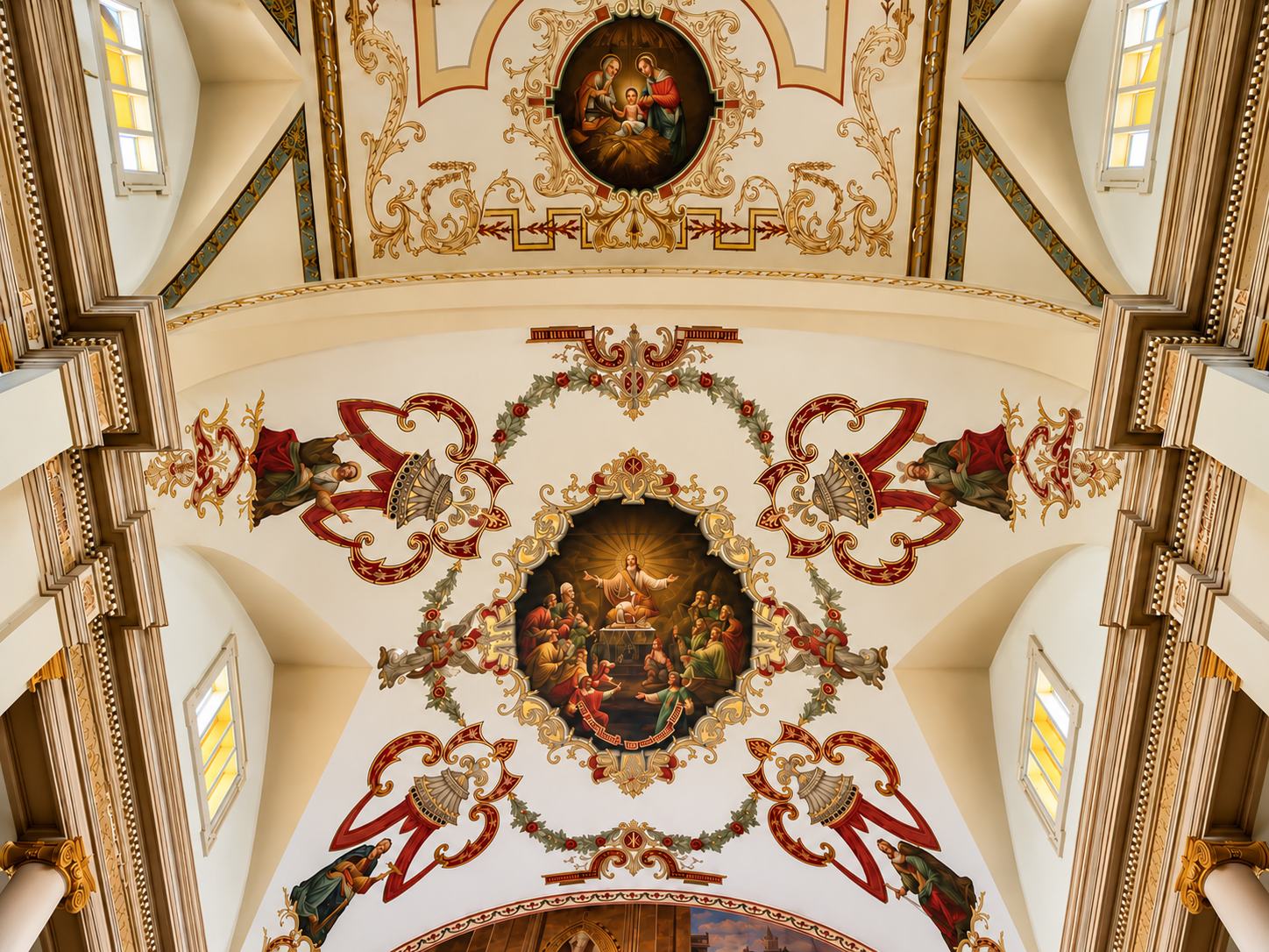 Painted ceiling medallions of the Nativity and Christ among the apostles, with a crystal chandelier