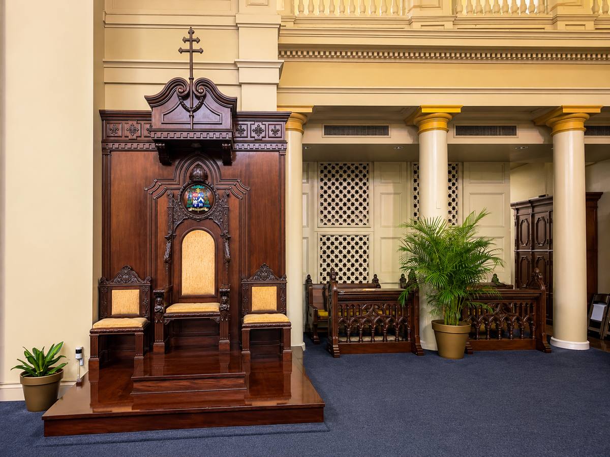The carved wooden cathedra, the archbishop's chair