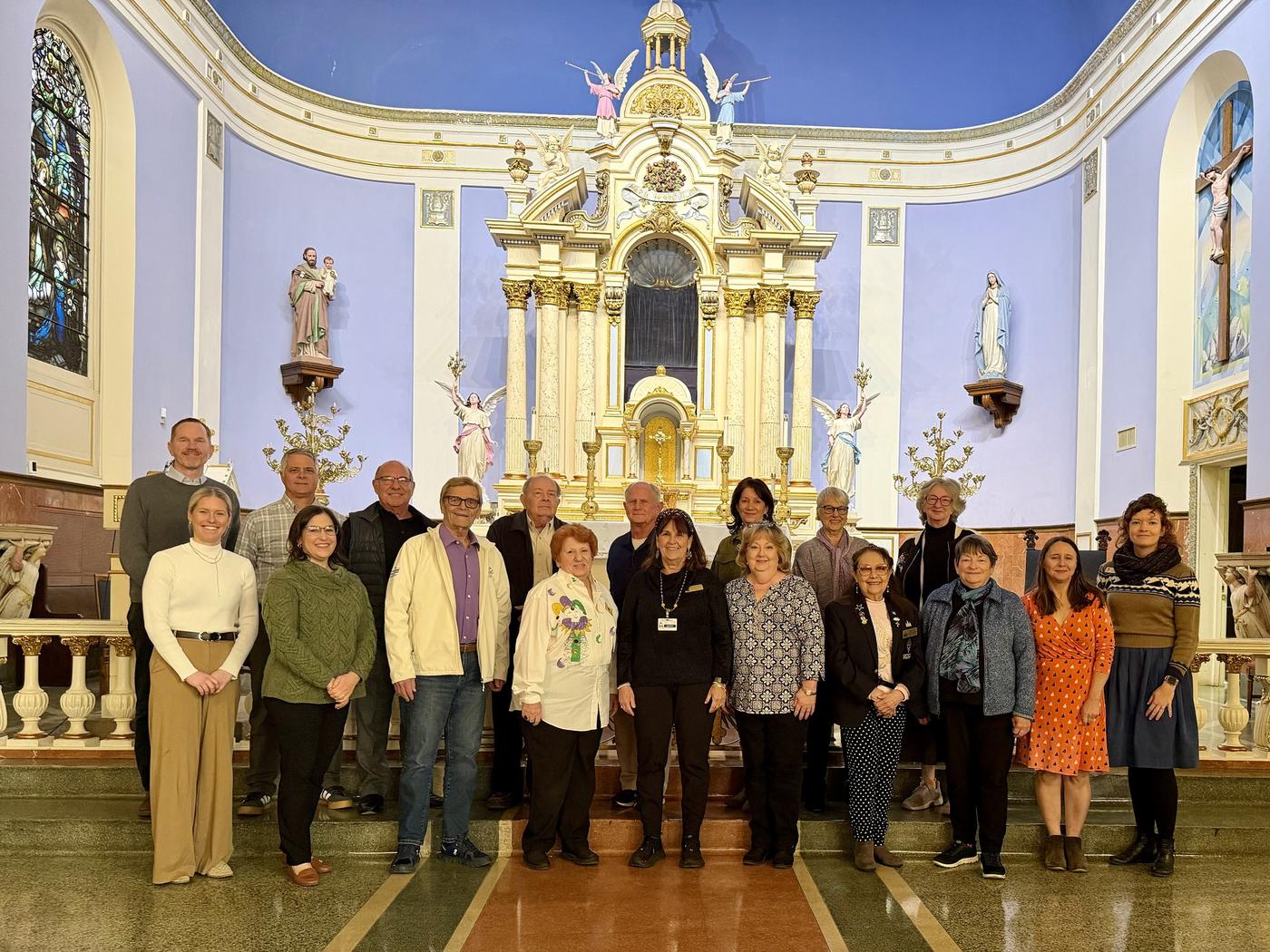 The cathedral's historians and docents gathered before an altar