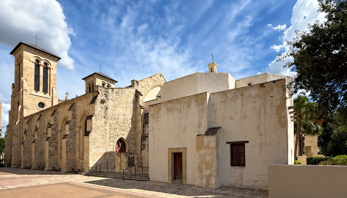 The side of San Fernando Cathedral: the Gothic Revival limestone nave at left, and at right the low white-stuccoed walls of the original eighteenth-century church.