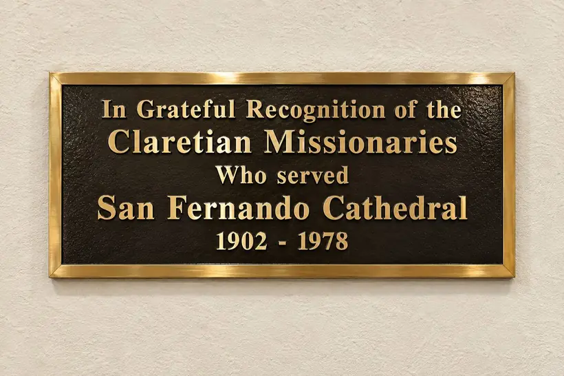 A bronze plaque with gold lettering reading: In Grateful Recognition of the Claretian Missionaries Who served San Fernando Cathedral, 1902-1978.